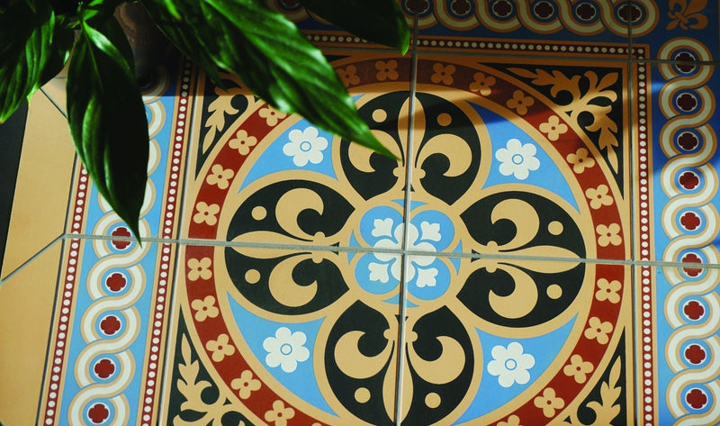 Vibrant blue black and gold ornate original style Victorian decorative floor tile with floral and scrollwork mosaic patterns