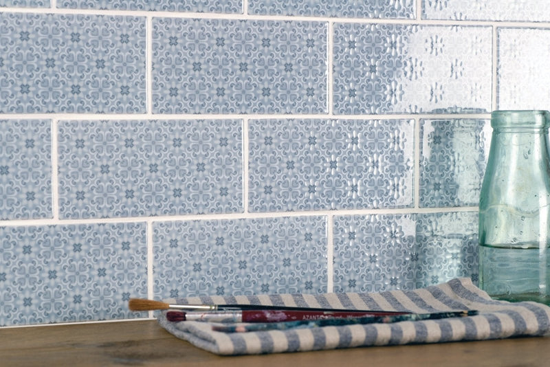 Blue and white striped cloth with paintbrushes resting on it in original style winchester tiles collection