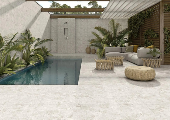 Light gray outdoor porcelain tiles with subtle natural veining and a matte finish stone patio tiles