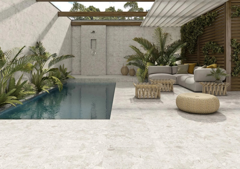 Light gray outdoor porcelain tiles with subtle natural veining and a matte finish stone patio tiles