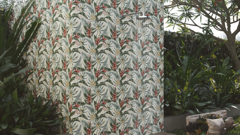 Tropical-patterned outdoor shower enclosure with white green and red foliage on off-white outdoor wall tiles