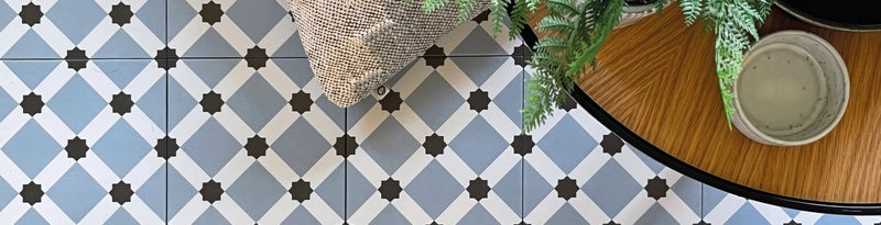 Blue and white geometric patterned patisserie ceramic floor tiles with black star shaped accents
