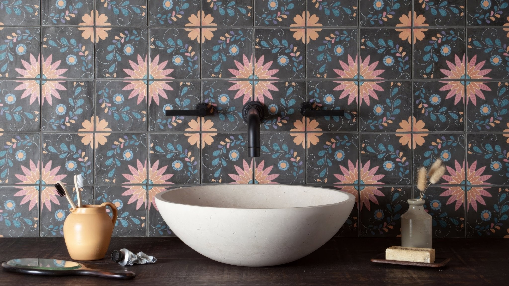 White stone vessel sink with smooth finish featured in a patterned bathroom tiles collection