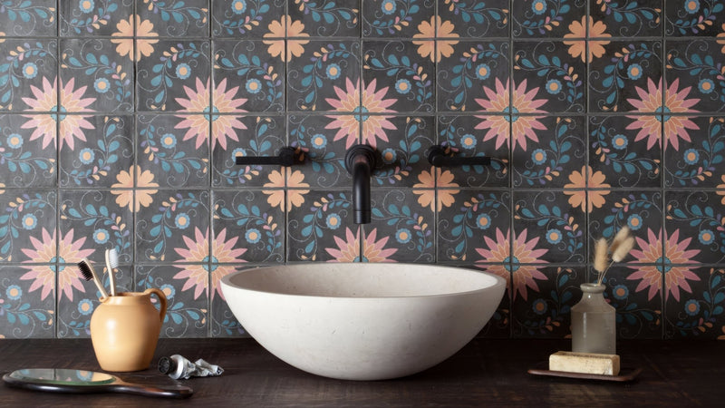 White stone vessel sink with smooth finish featured in a patterned bathroom tiles collection