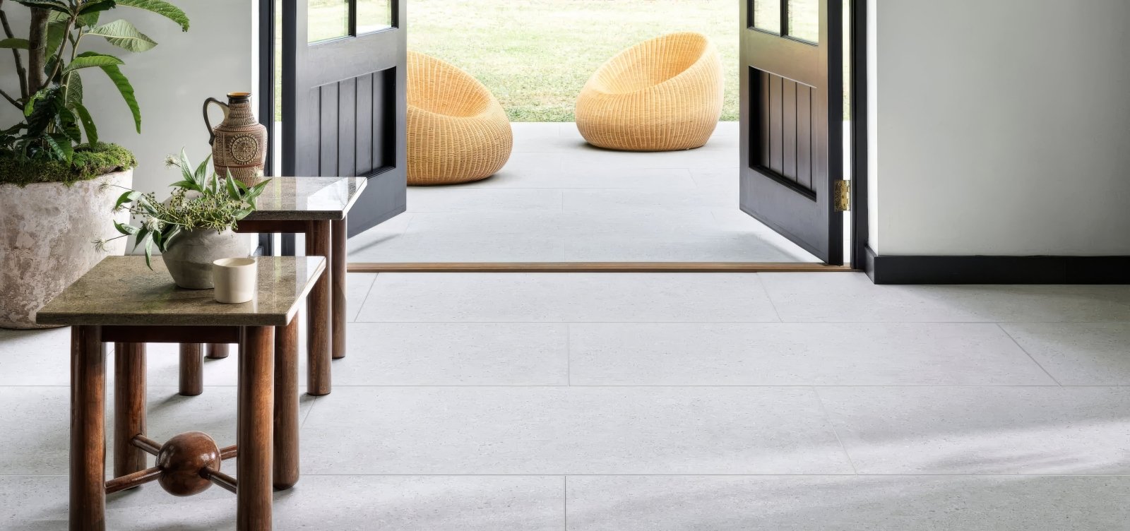 Woven wicker lounge chairs in natural light beige with rounded organic design from piazza tiles collection