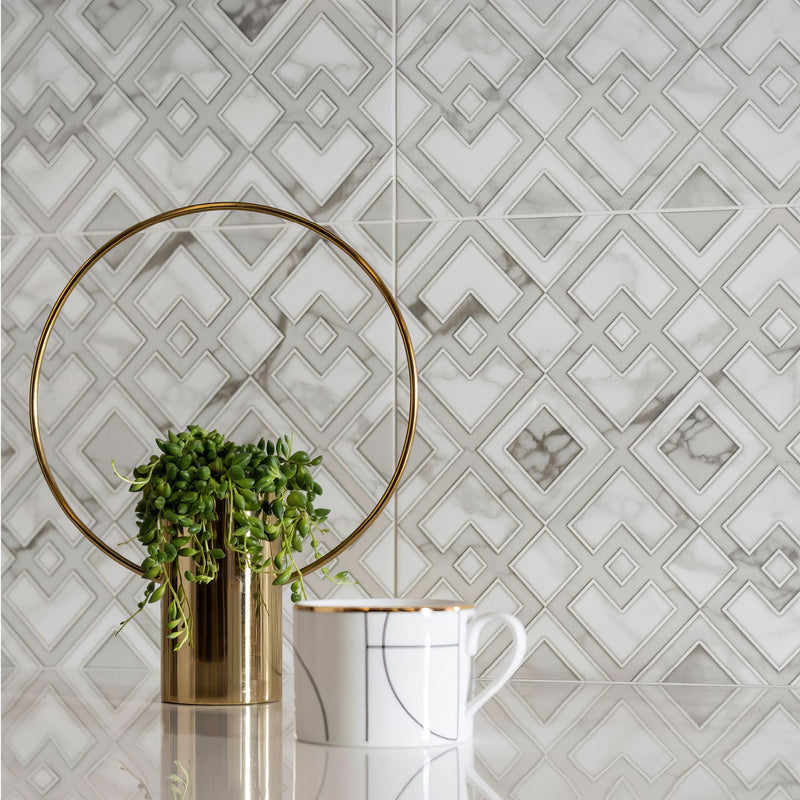 Gold cylindrical planter with circular gold ring and green trailing plant from palazzo collection