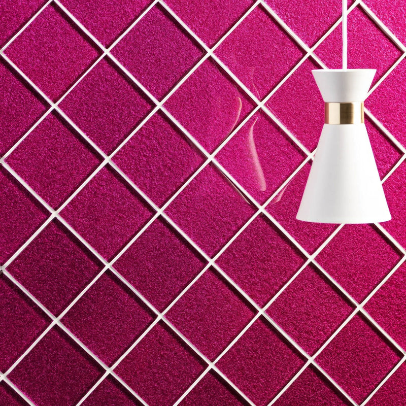 A sleek white pendant lamp with gold accent hangs against a vibrant magenta glittery tiled wall in pink tiles collection