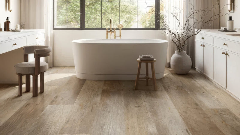 White freestanding bathtub with gold-toned faucet and minimalist design in plank bathroom tiles collection