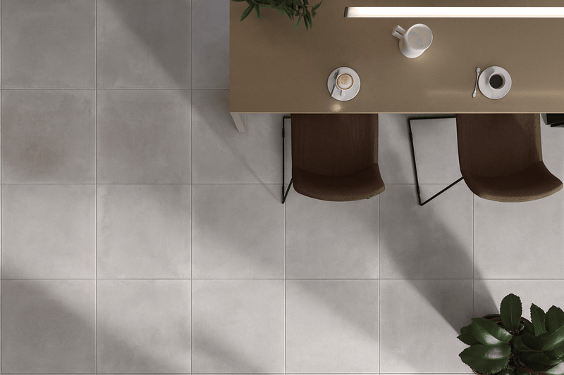 Light gray matte-finish porcelain floor tiles in square shape designed for durable indoor flooring use
