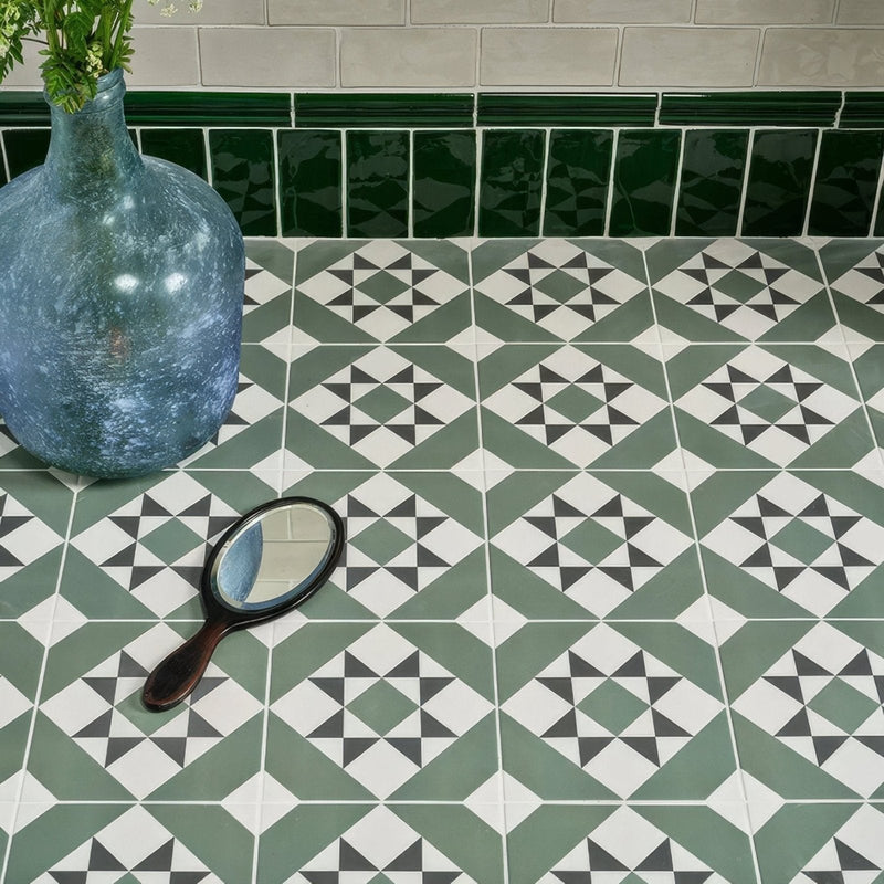 A vintage-style hand mirror with a dark wooden handle and oval reflective surface from Brompton Porcelain collection.