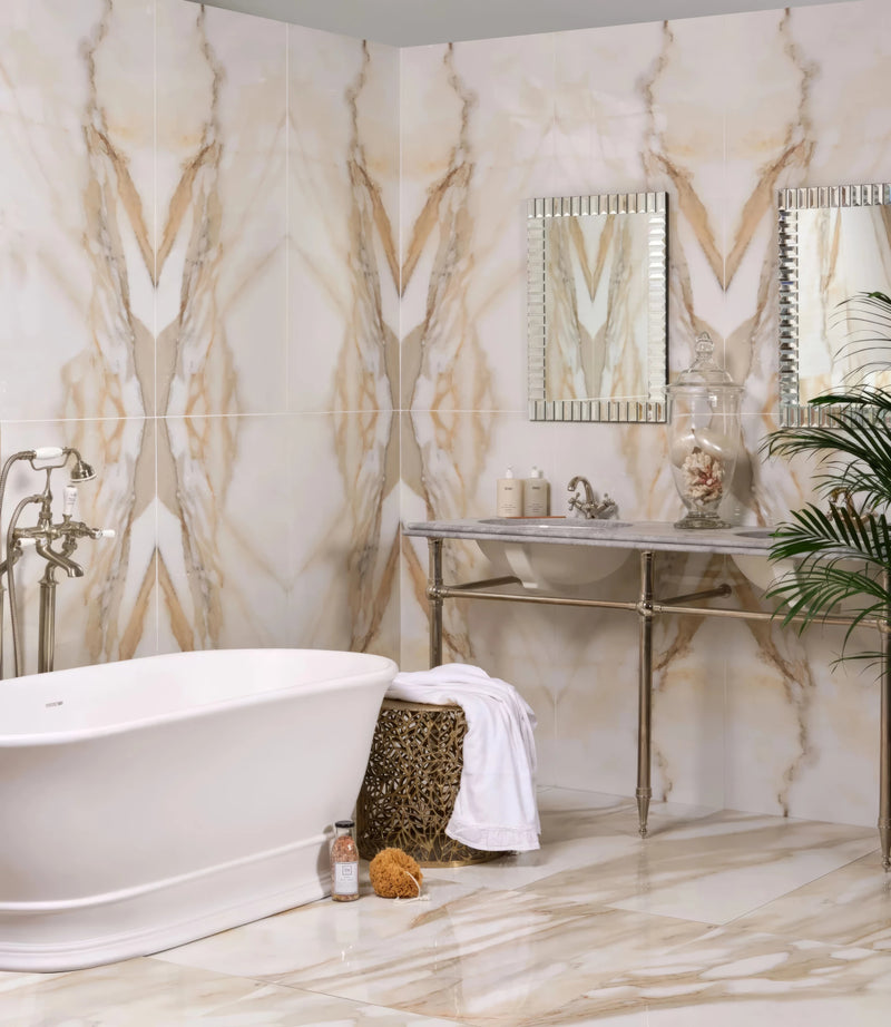The Portare Collection by Ca Pietra Tiles features cream marble tiles with golden veining in a symmetrical bathroom design.