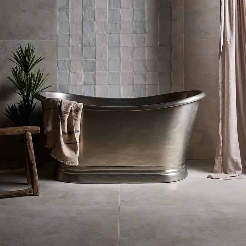 Polished silver freestanding porcelain bathtub with classic oval shape and elegant flared rim from southdown porcelain collection
