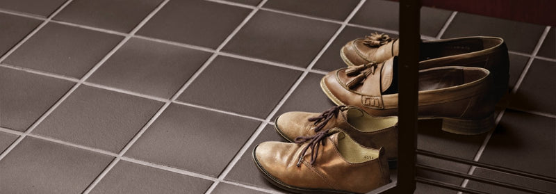 A pair of tan leather oxford shoes with lace-up design low heel and decorative tassels from quarry tiles collection