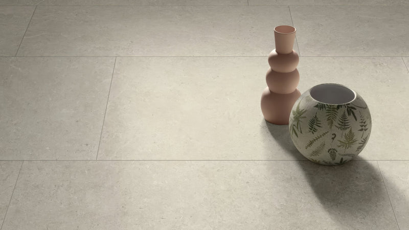 A round ceramic vase with white base and green fern patterns beside a taller terracotta stacked vessel in rectangle kitchen tiles collection