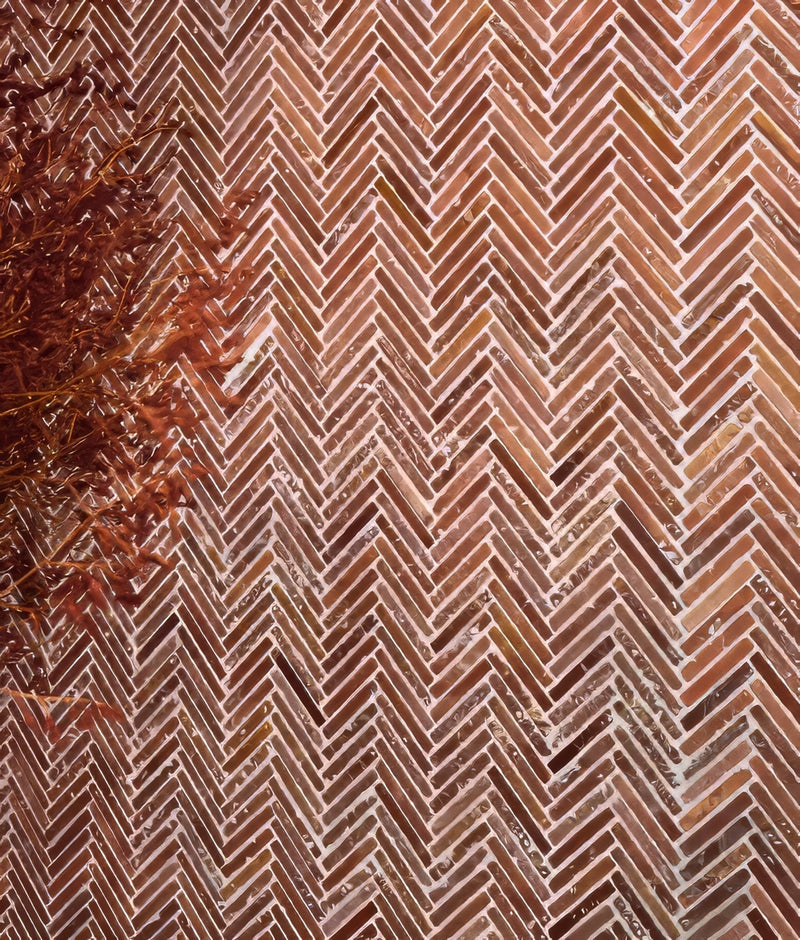Brown textured ceramic tiles arranged in a herringbone pattern from the red mosaic tiles collection