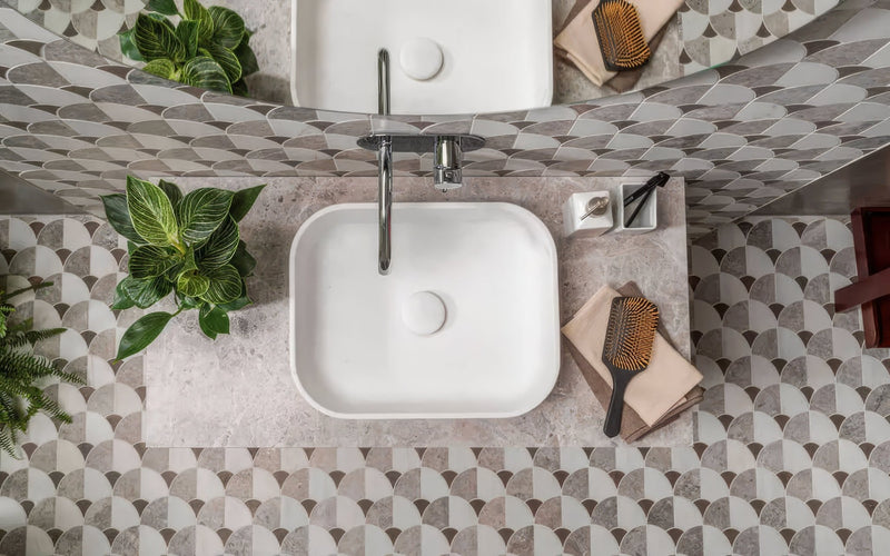 White square ceramic sink with sleek chrome faucet paired with scallop floor tiles in modern bathroom setting