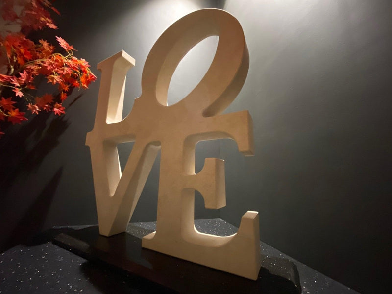 Beige wooden love letter sculpture with smooth matte finish and clean cut edges in sculptures collection.