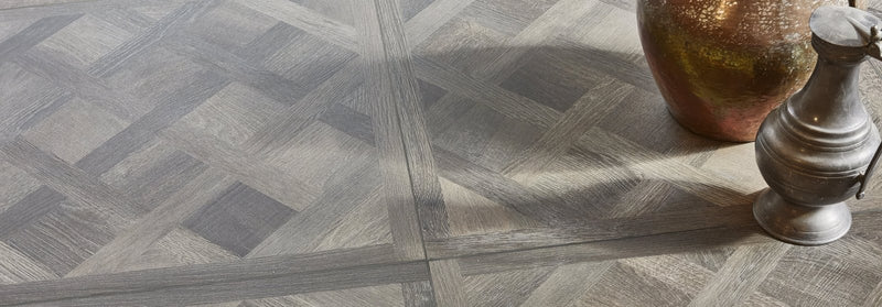 Gray wood-patterned parquet flooring in sherwood collection with geometric diamond design