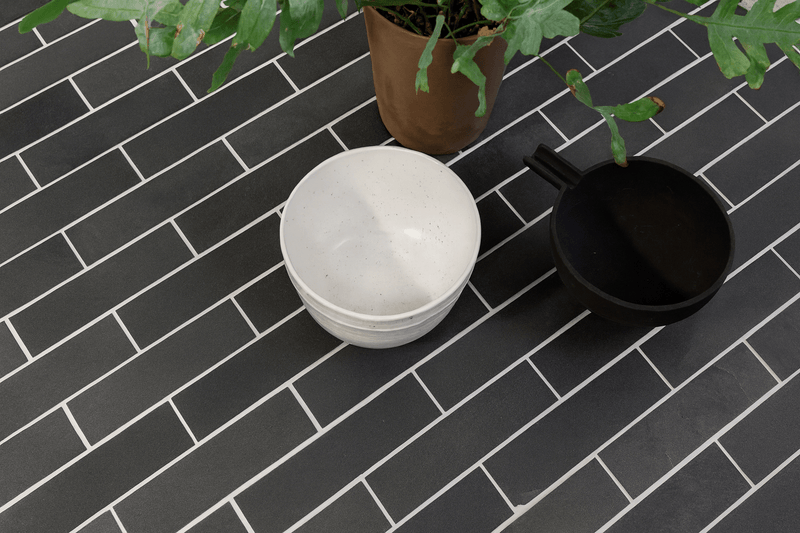 White ceramic bowl with subtle speckles and smooth rounded rim featured in slate floor tiles collection