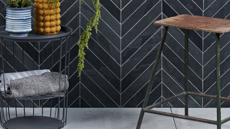 Black herringbone patterned slate wall tiles with white grout lines for stylish interior wall decor