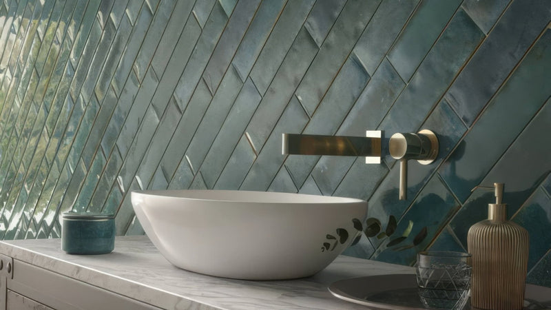 White ceramic vessel sink with subtle leaf decals featured in splashback wall tiles collection