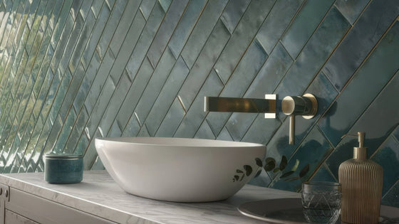 White ceramic vessel sink with subtle leaf decals featured in splashback wall tiles collection