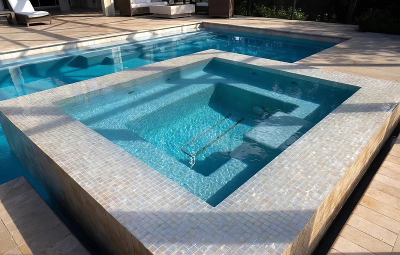Modern rectangular hot tub with light beige mosaic tile surround and clear blue water in swimming pool mosaic tiles collection