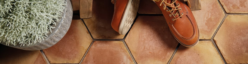 Tan leather red wing work boots with tan laces and a classic sturdy design in terracotta kitchen tiles collection