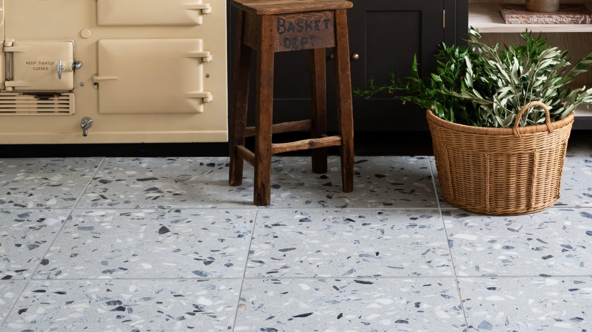 Terrazzo kitchen floor tiles with light gray base and scattered black white and beige aggregate pieces