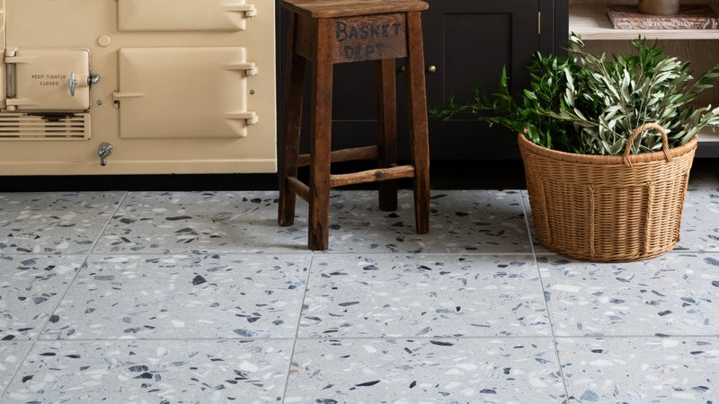 Terrazzo kitchen floor tiles with light gray base and scattered black white and beige aggregate pieces