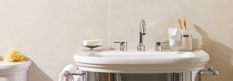 White ceramic sink with chrome fixtures and a curved basin in the umbrian tiles collection