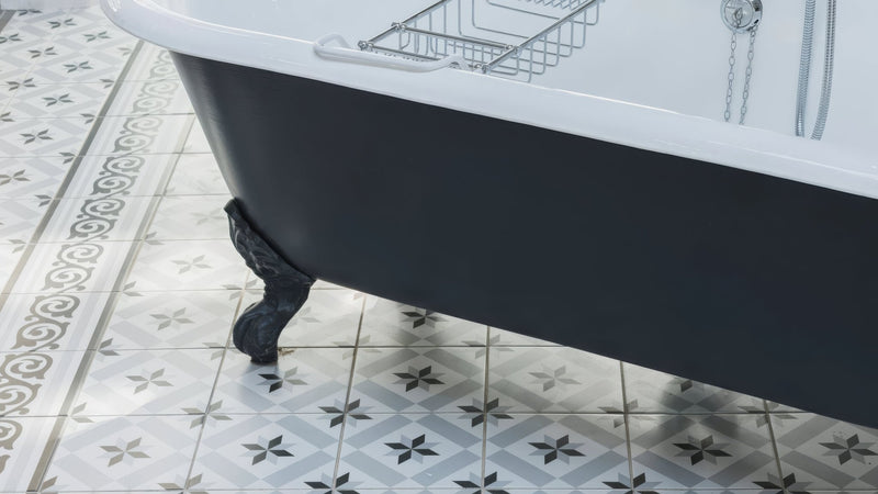 Black clawfoot bathtub with white interior and chrome fixtures in a Victorian bathroom tiles collection