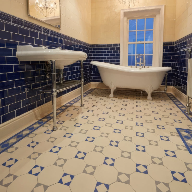 White clawfoot bathtub with chrome fixtures and ornate legs on victorian floor tiles arundel pattern