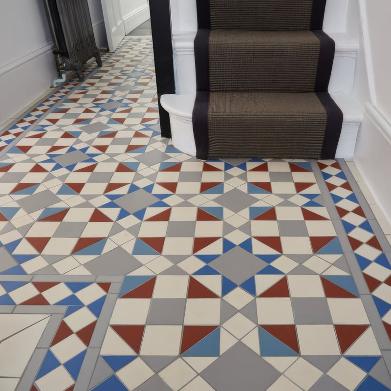 Geometric patterned red blue and gray floor tiles on cream background from victorian floor tiles eltham pattern collection