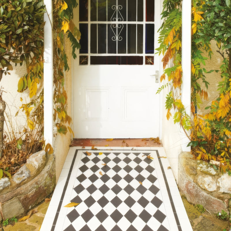 White front door with decorative black and white wrought iron window grille in victorian floor tiles st andrews pattern collection
