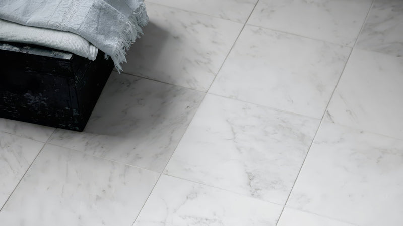 White kitchen tiles featuring white marble floor tiles with subtle gray veining for elegant flooring options