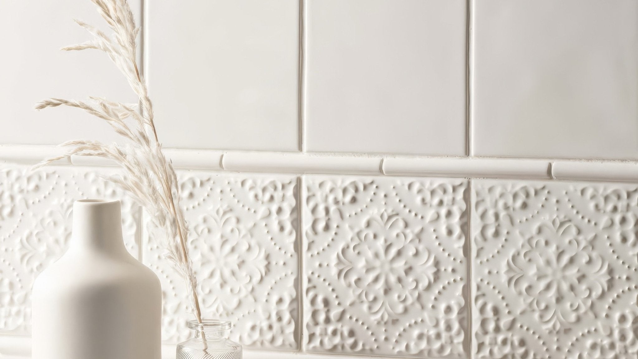 White ceramic wall tile with raised floral embossing in a collection titled white wall tiles