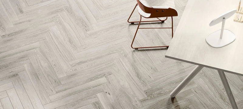 Light gray wood-grain herringbone patterned wood floor tiles ideal for stylish indoor flooring designs