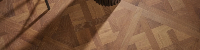 Parquet wood flooring with warm medium brown finish and intricate geometric pattern from woodpeck warwick waterproof panels collection