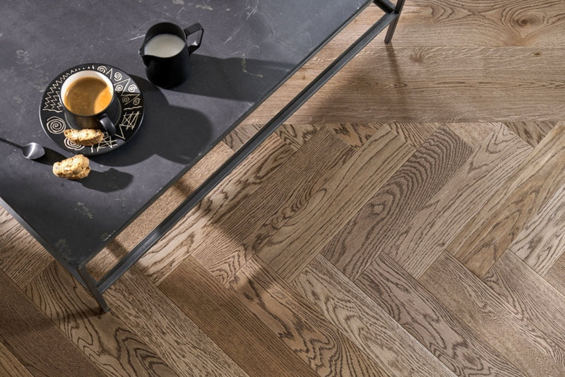 Light brown wood floor with herringbone pattern from Woodpecker Goodrich hardwood flooring collection.