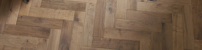 Light brown hardwood floor in a herringbone pattern from the woodpecker orkney herringbone collection