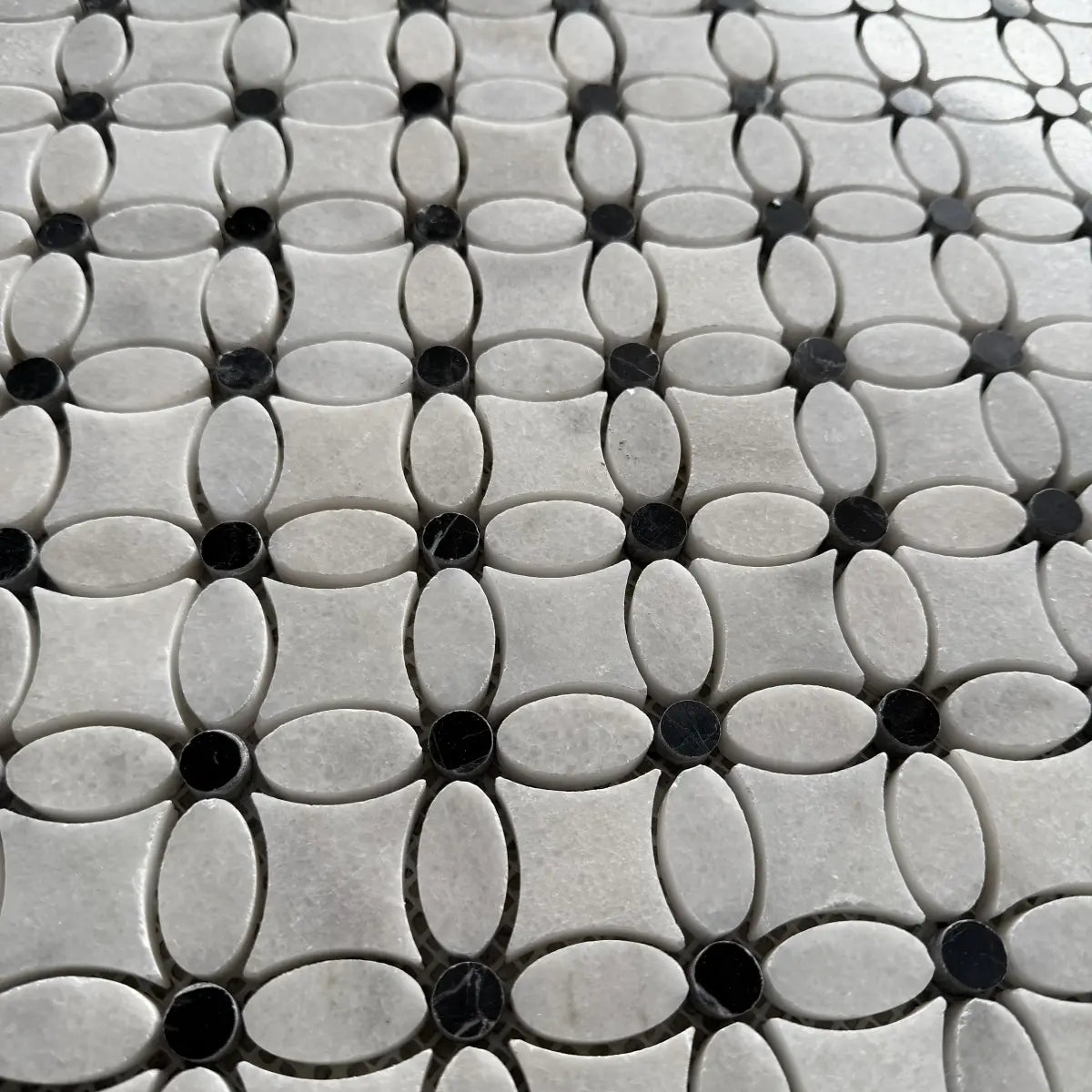 Black dot Carrara marble flower mosaic used as a cloakroom floor