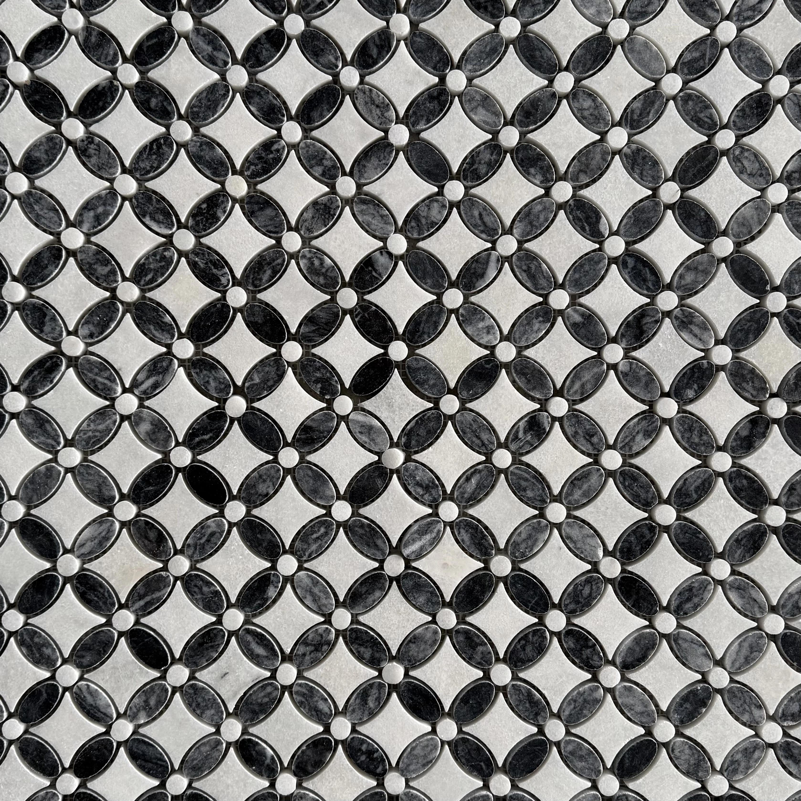 Close detail of the black marble centres and white Carrara petals in the flower motif