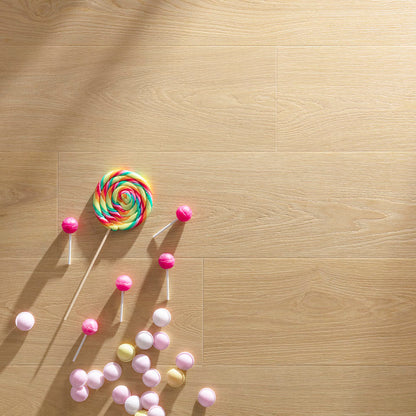 Paris tan f001 long vinyl planks on light wood flooring with a vibrant rainbow swirl lollipop and pink white candies