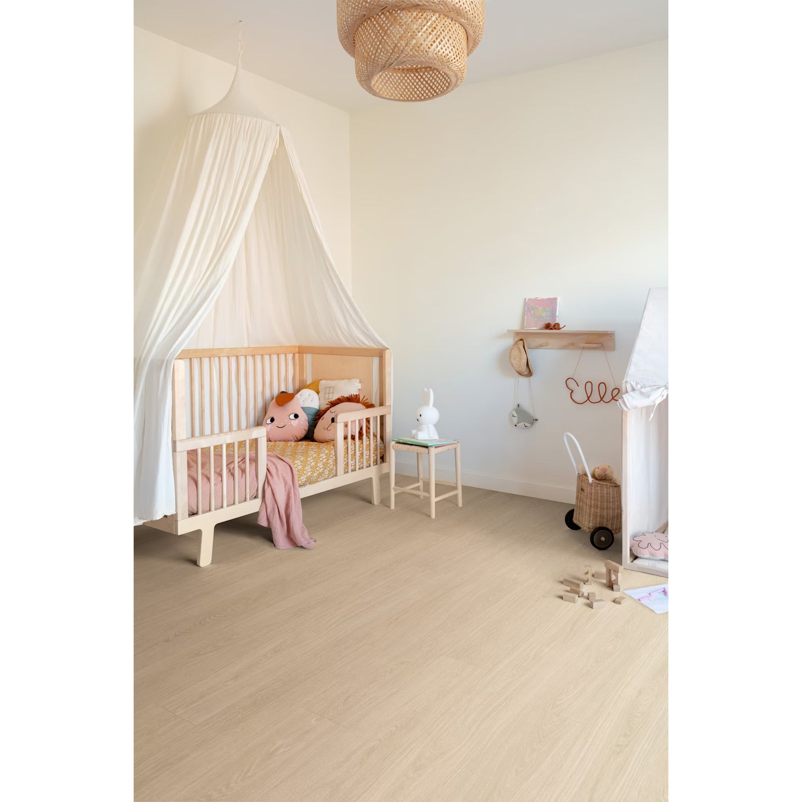 Light-colored wooden crib with white canopy on popcorn f056 vinyl planks floor showcasing bedroom decor