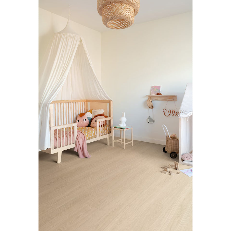Light-colored wooden crib with white canopy on popcorn f056 vinyl planks floor showcasing bedroom decor