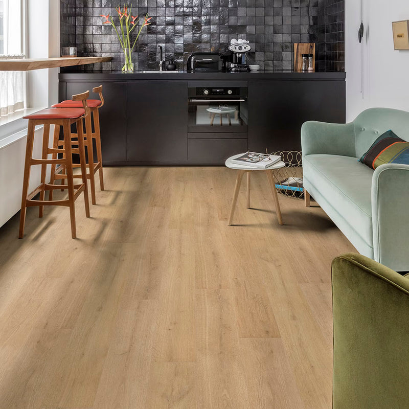 Modern kitchen with LVT wooden flooring, bar stools, and a sofa.
