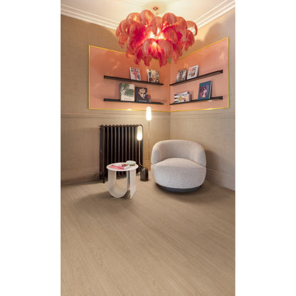 A vibrant red feather chandelier with a sculptural layered design hanging above waffle f057 vinyl plank flooring