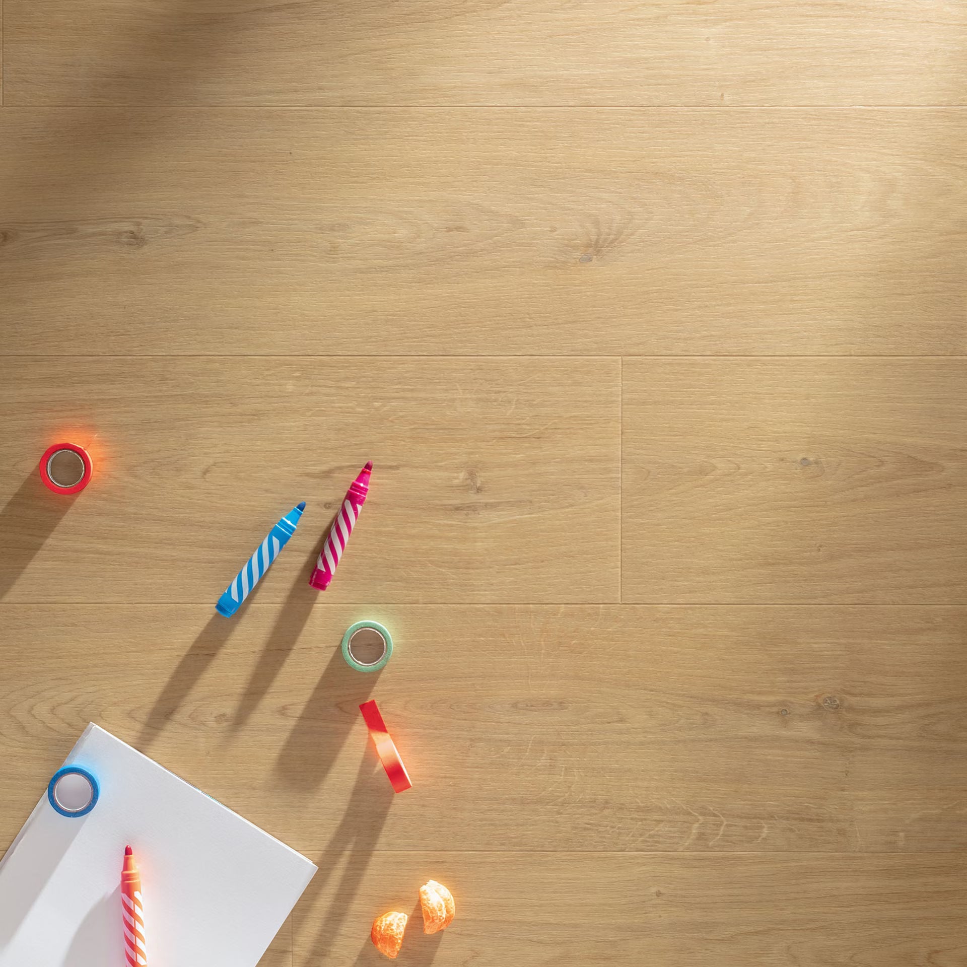 Light brown croissant f007 long vinyl planks with subtle grain patterns and visible seams between wooden floorboards