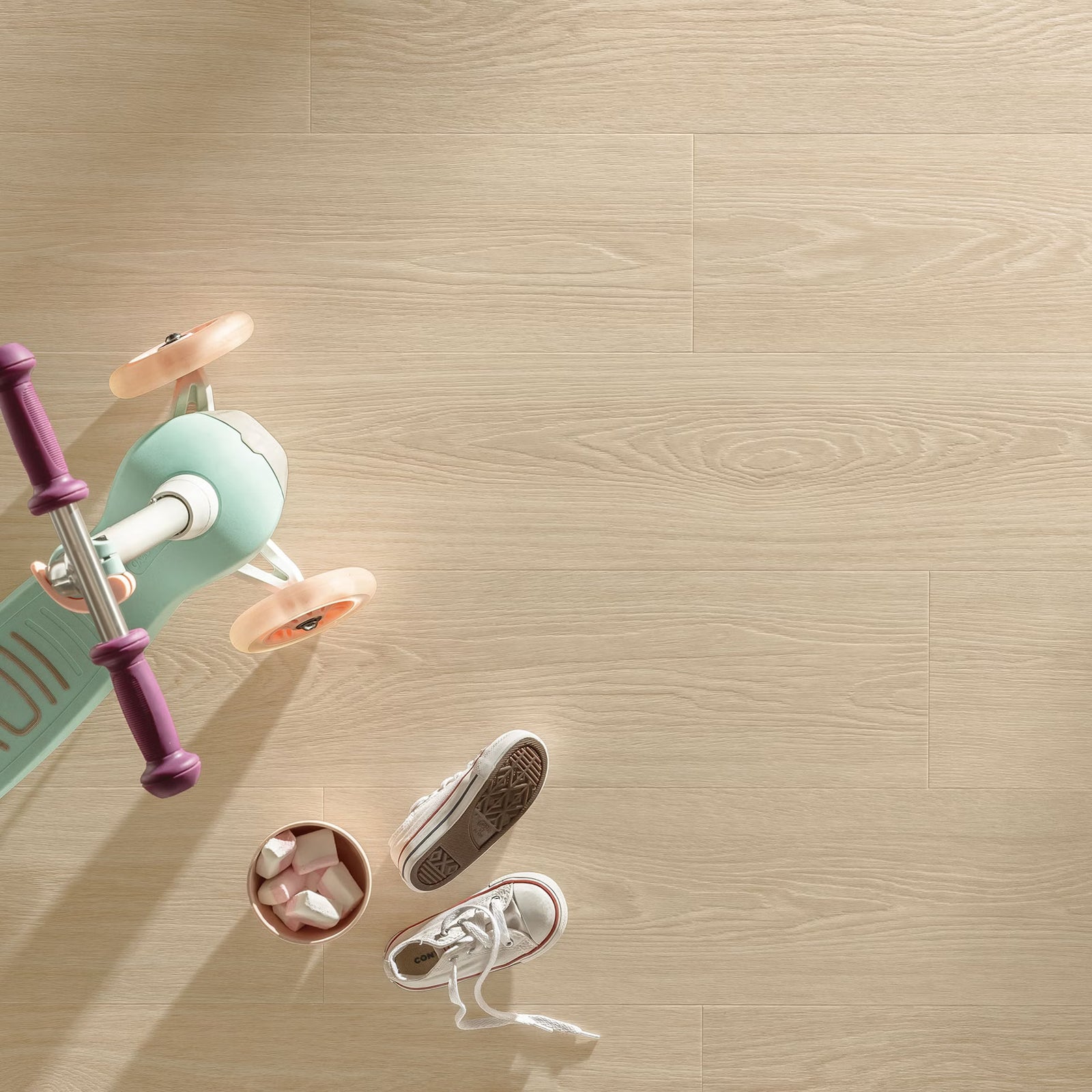 Mint green and purple children’s scooter with peach vinyl wheels on popcorn f056 vinyl planks flooring